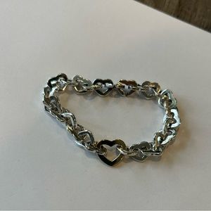 Tiffany sterling silver heart bracelet with gold center heart.